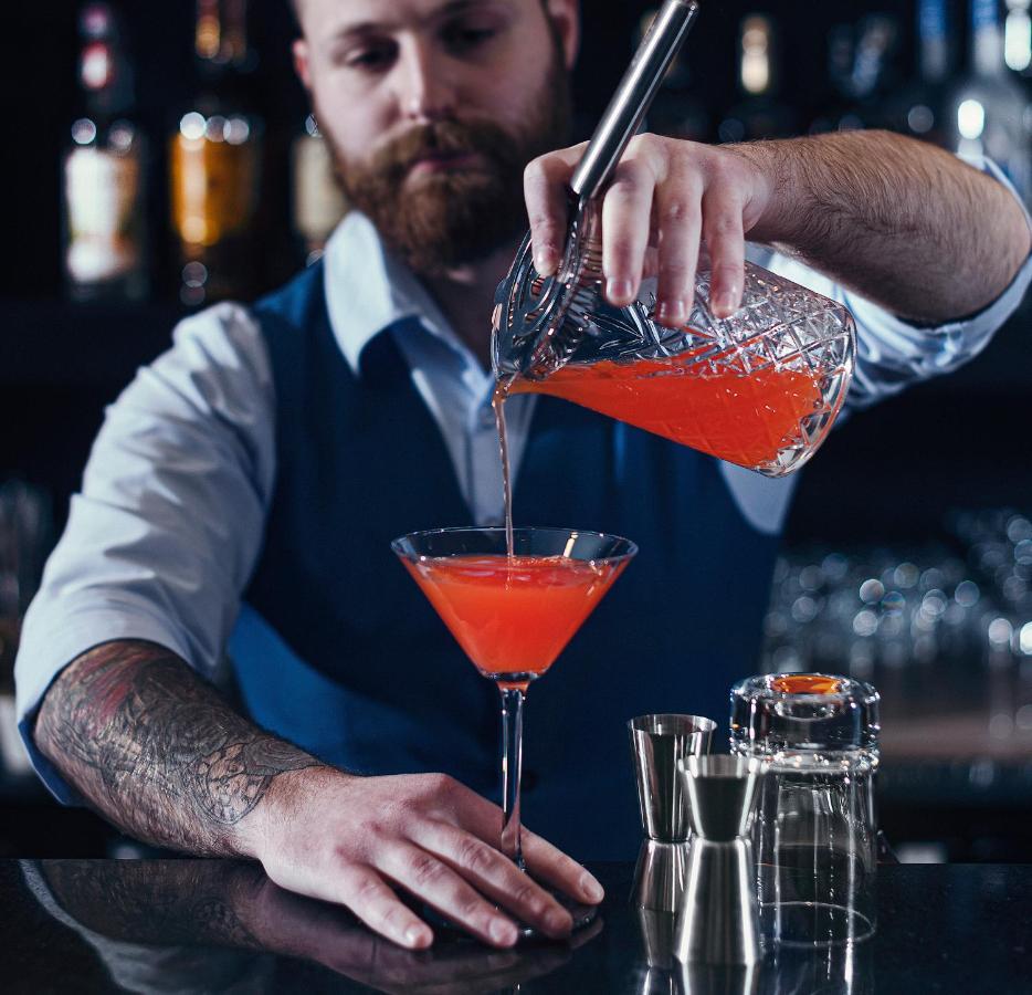 Royal Tulip Hotel & Casino, Tbilisi Exterior photo A bartender preparing a cocktail